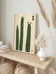 Minimalist illustration of three green cactus plants with Japanese-style text and a red seal, in an alternate framed mockup