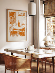 Vintage orange cafe street scene illustration print with a table, bottle, and chairs on a light background. - Image 3