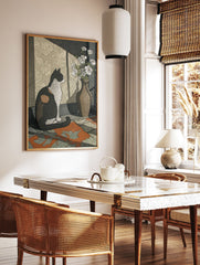 Illustrative calico cat wall art print sitting next to a vase of white flowers, with sunlight casting shadows on patterned wallpaper. - Image 3
