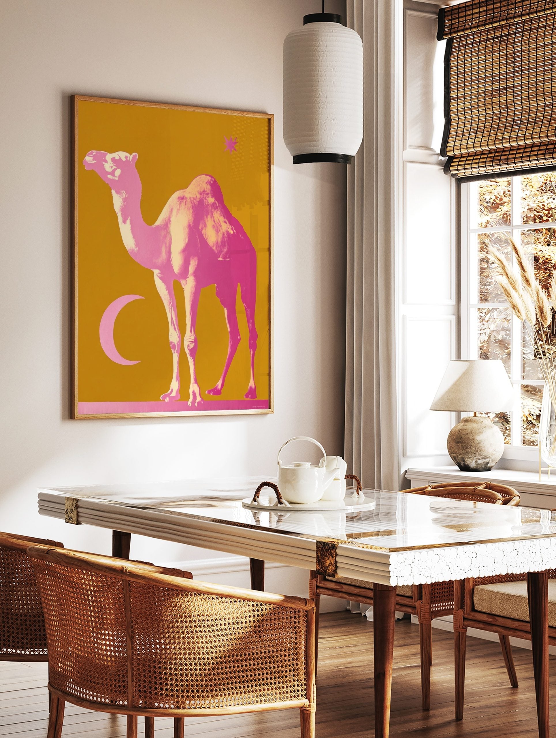 Pink camel, crescent moon, and star on a mustard yellow background, in a bold illustrative style, in a styled room mockup
