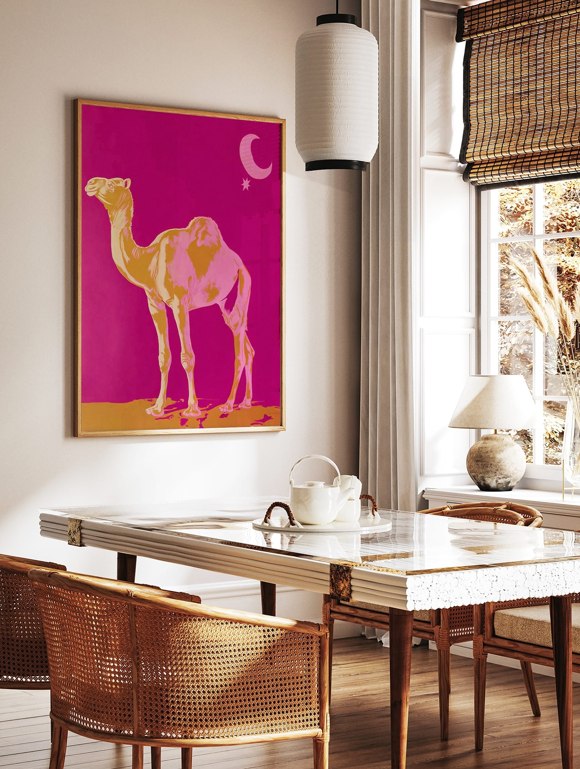 Golden yellow and pink camel standing on sand against fuchsia sky with moon and star, in a styled room mockup