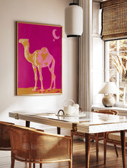 Golden yellow and pink camel standing on sand against fuchsia sky with moon and star, in a styled room mockup
