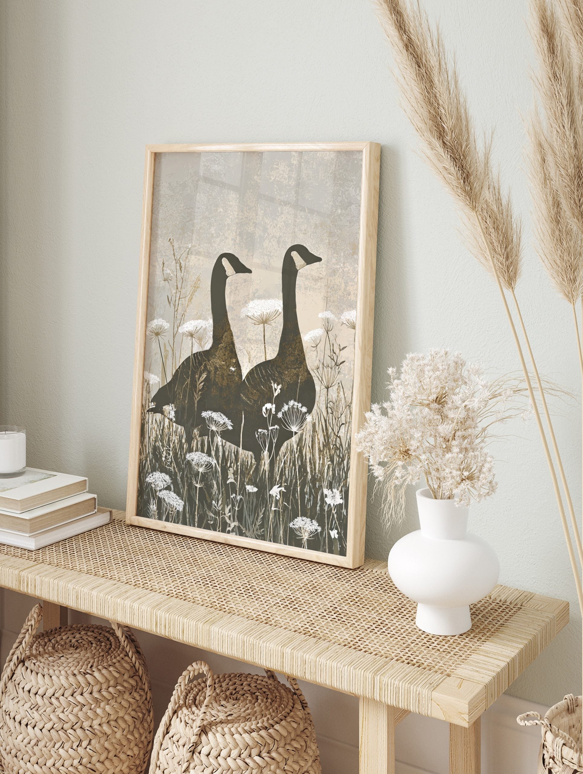Two Canada geese silhouettes stand in a field of white Queen Anne's Lace flowers, earthy, in an alternate framed mockup
