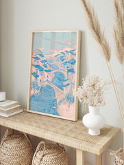 Illustrative blue and pink Canal City Wall Art depicting a European river town with bridges, boats, and buildings. - Image 3