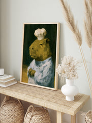 Painterly oil art print of a capybara wearing a white chef hat against a dark background, in an alternate framed mockup
