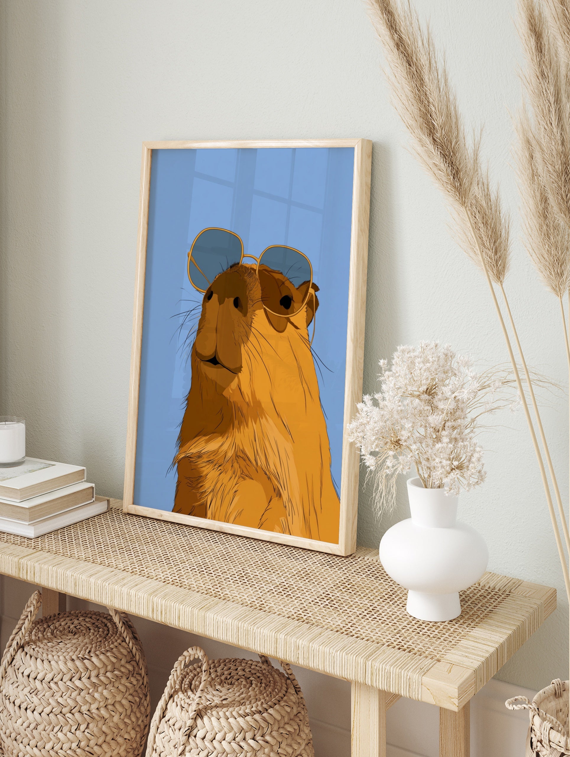 Illustrated capybara wearing oversized sunglasses against a solid blue background, in an alternate framed mockup