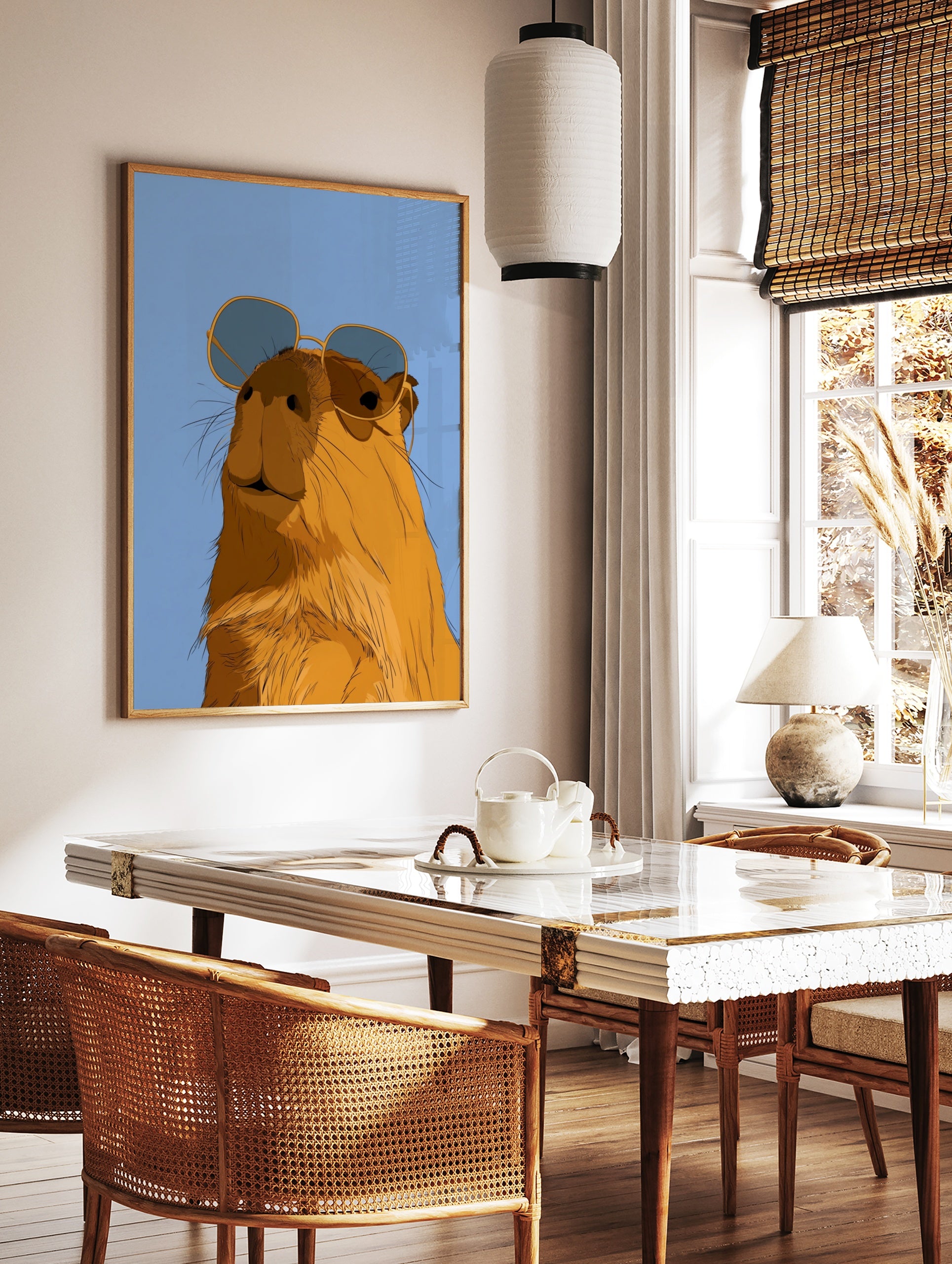 Illustrated capybara wearing oversized sunglasses against a solid blue background, in a styled room mockup