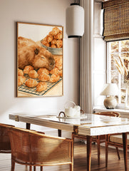Watercolour illustration of a sleeping capybara resting on a wire rack filled with golden croissants, in a styled room mockup