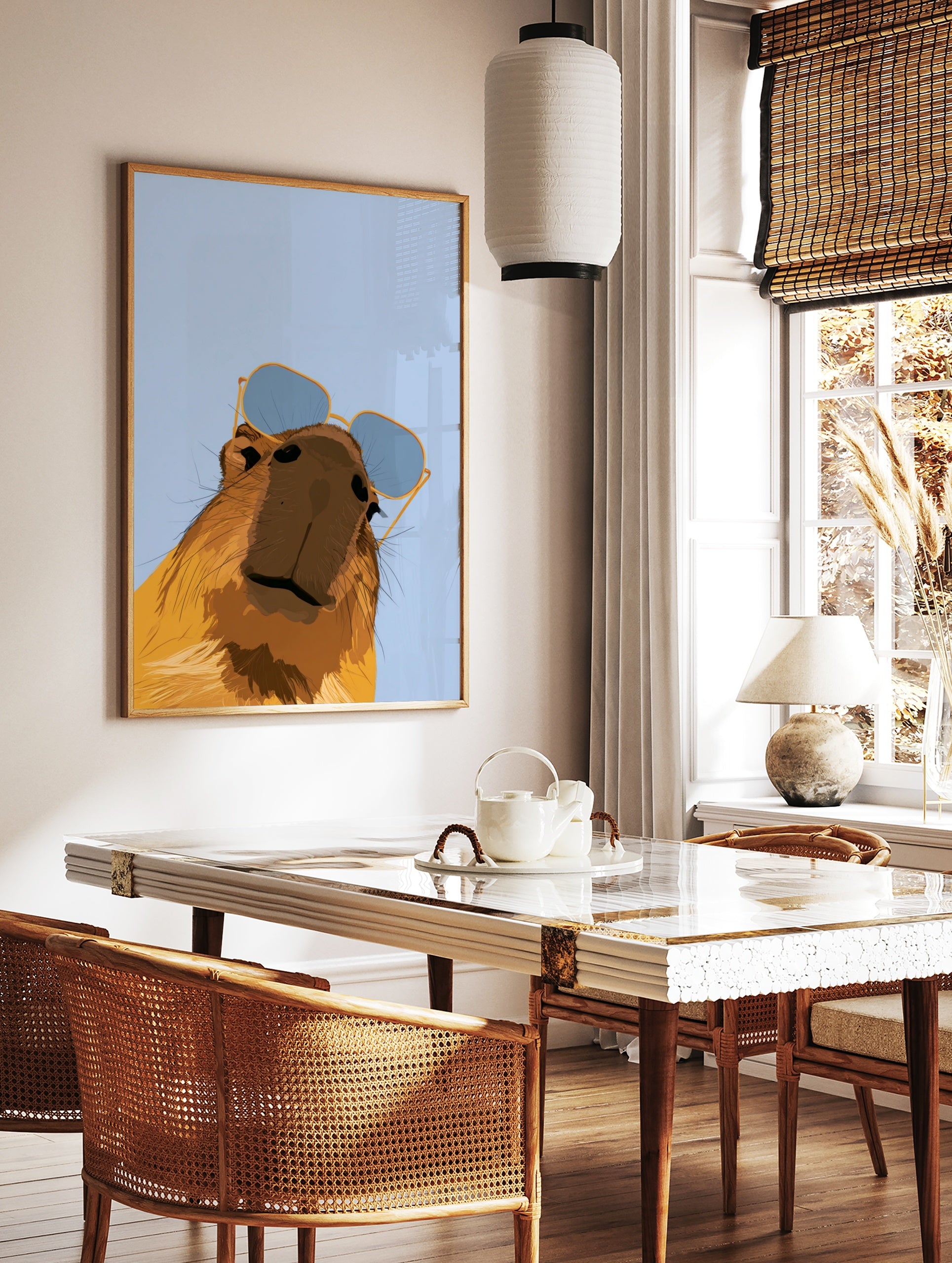 Stylised capybara illustration wearing blue-tinted sunglasses against a light blue background, in a styled room mockup