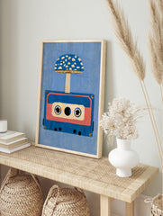 Retro illustration of an audio cassette tape with a blue spotted mushroom growing from it, in an alternate framed mockup