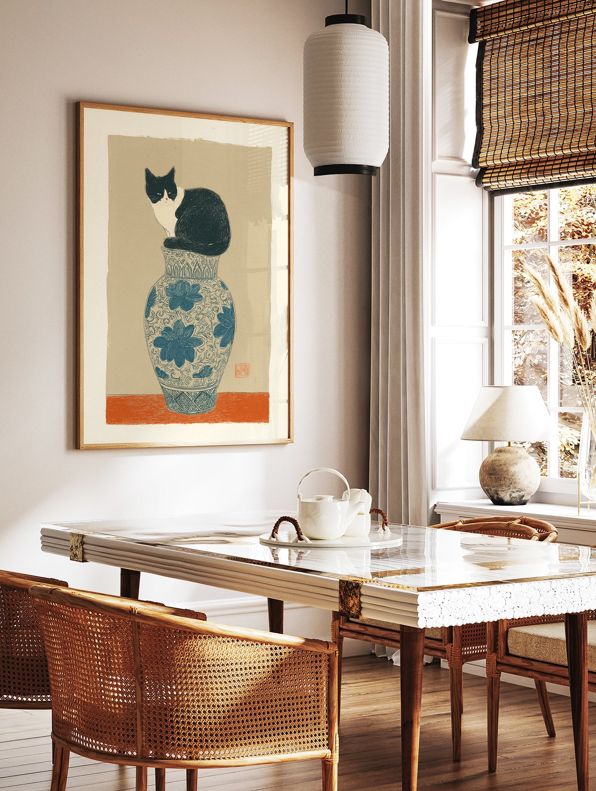 Illustrative cat art print showing a black and white cat sitting on a blue and white patterned vase against a tan background. - Image 2