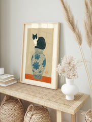 Illustrative cat art print showing a black and white cat sitting on a blue and white patterned vase against a tan background. - Image 3