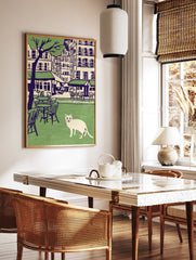 Illustration of a white cat in a green park with cafe tables, chairs, city buildings, and a tree in the background. Cat wall art. - Image 2