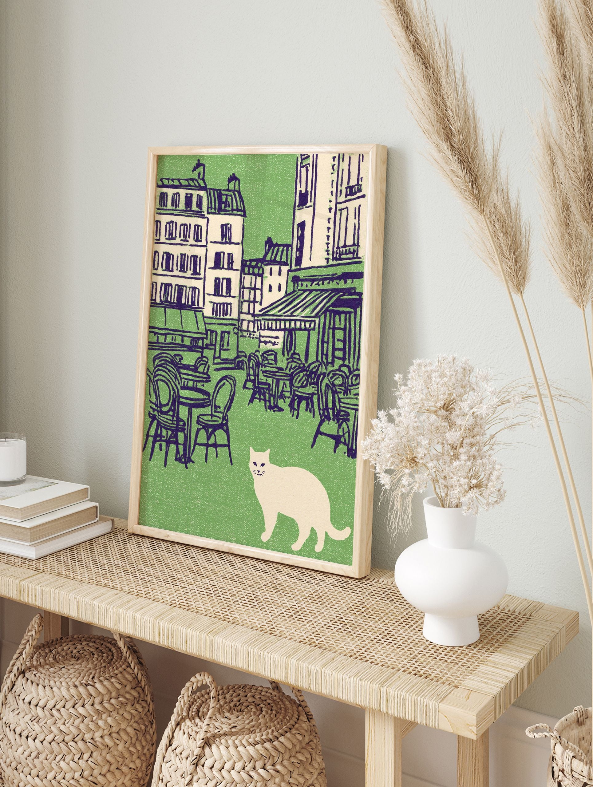 Vintage illustration of a white cat in front of a green Parisian cafe scene with outdoor tables and buildings. Cat wall art. - Image 3