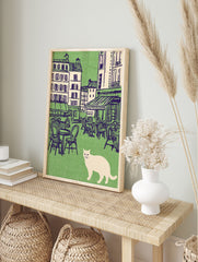 Vintage illustration of a white cat in front of a green Parisian cafe scene with outdoor tables and buildings. Cat wall art. - Image 3