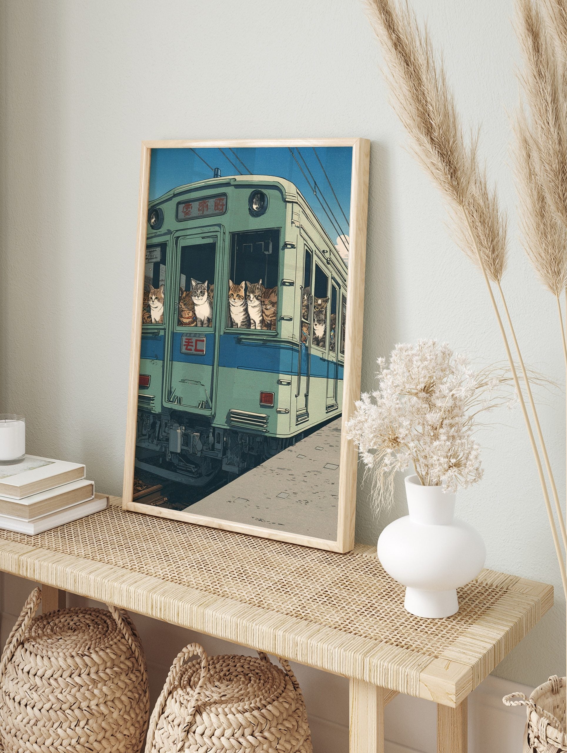 Illustrative art print of various cats looking out of the windows of a green Japanese train, in an alternate framed mockup