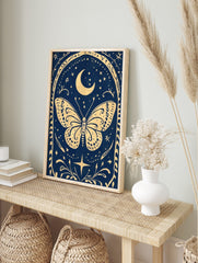 Illustrative celestial butterfly wall art with crescent moon, stars, and ornate border on a, in an alternate framed mockup