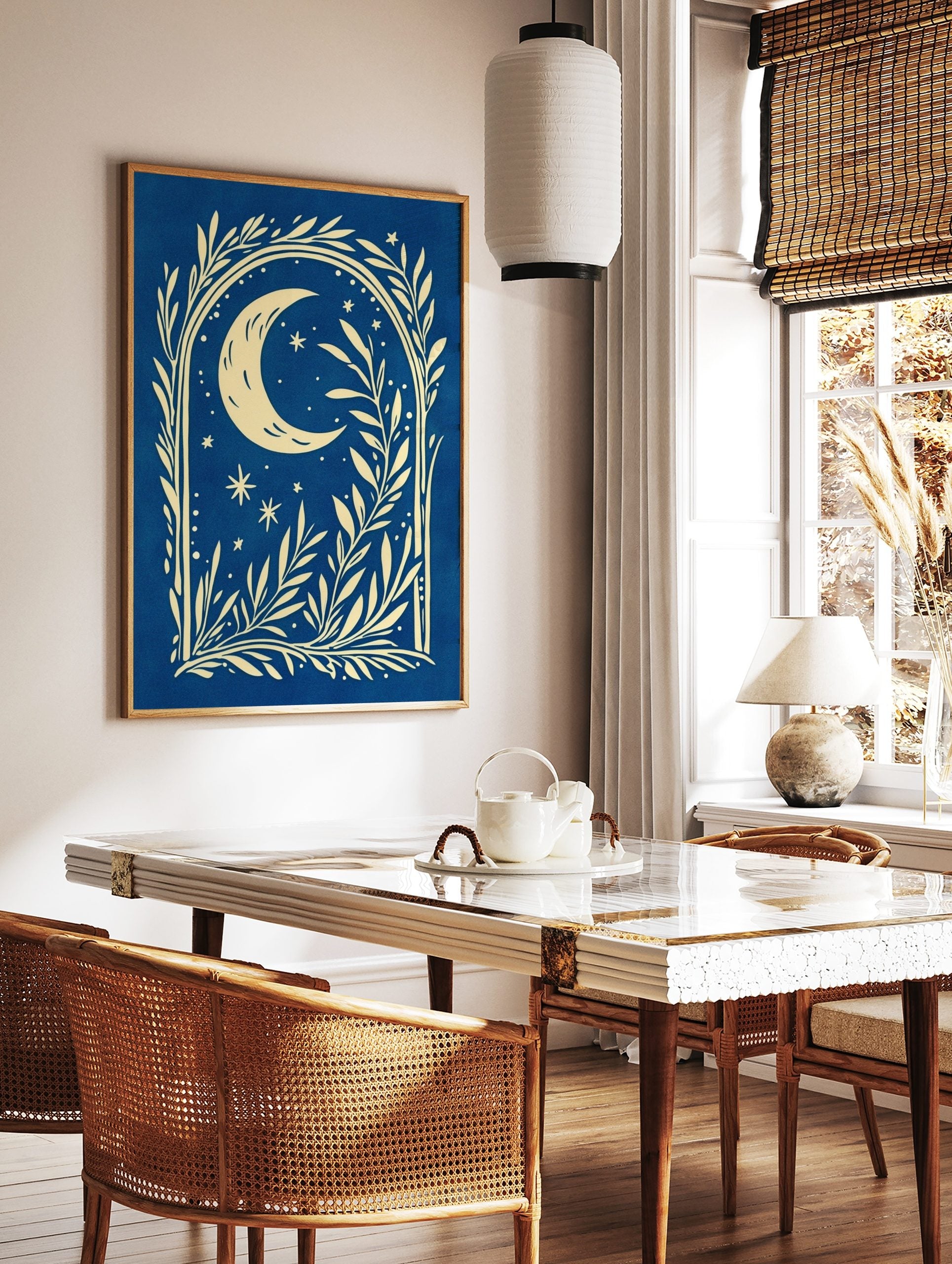 Illustrative cream crescent moon and stars with botanical foliage on a deep blue background, in a styled room mockup