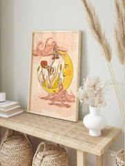Celestial crescent moon with a face holding whimsical mushrooms and plants, surrounded by stylized clouds, displayed as the same artwork in an alternate framed wall art mockup