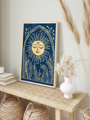 Illustrative print of a smiling sun with leafy plants in an arched frame on a blue background, in an alternate framed mockup