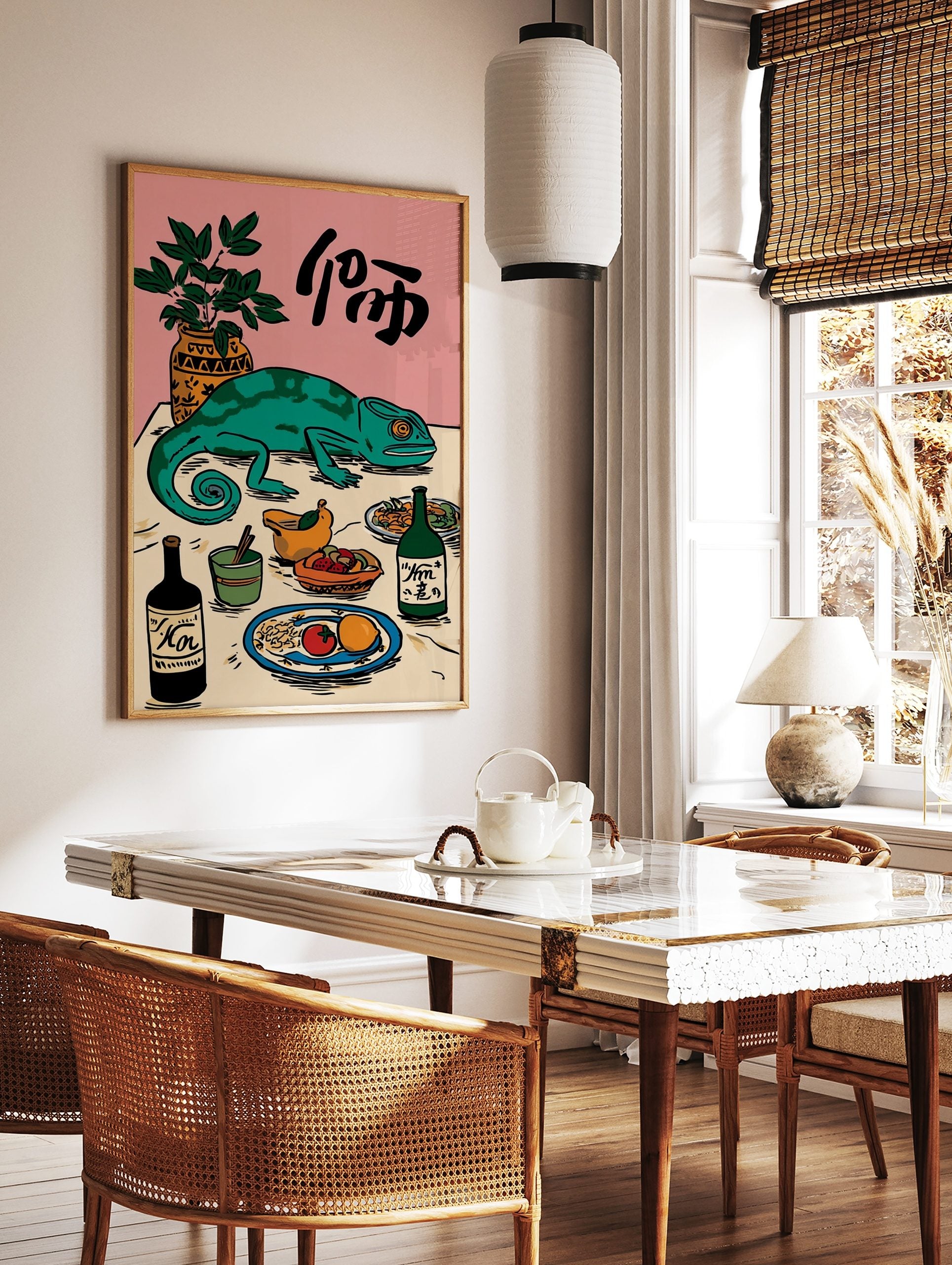 Illustrative green chameleon on a table with food, drinks, a plant, and Japanese characters on a, in a styled room mockup