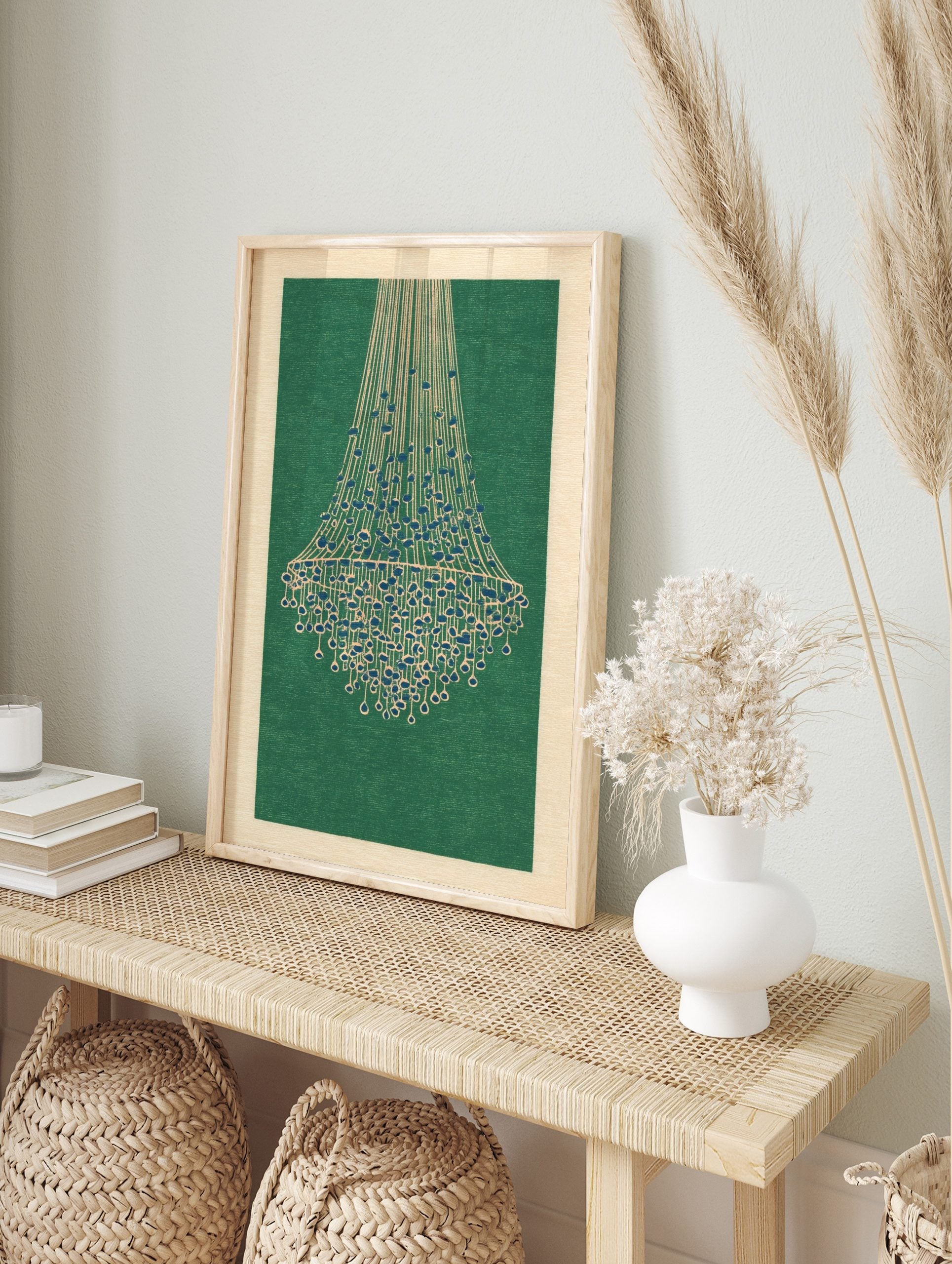 Illustrative chandelier wall art print with cream lines and blue beads on a deep green, in an alternate framed mockup