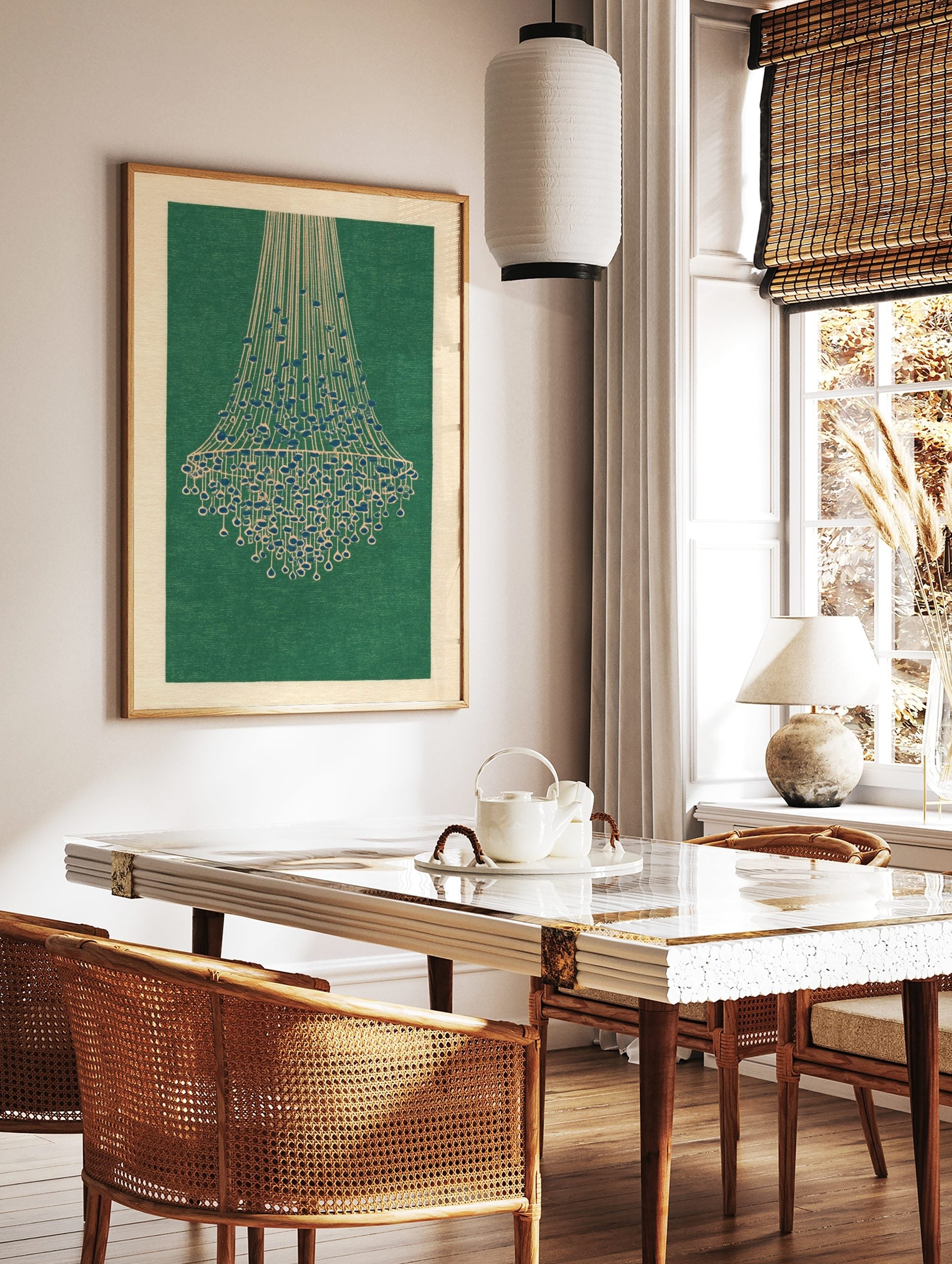 Illustrative chandelier wall art print with cream lines and blue beads on a deep green background, in a styled room mockup