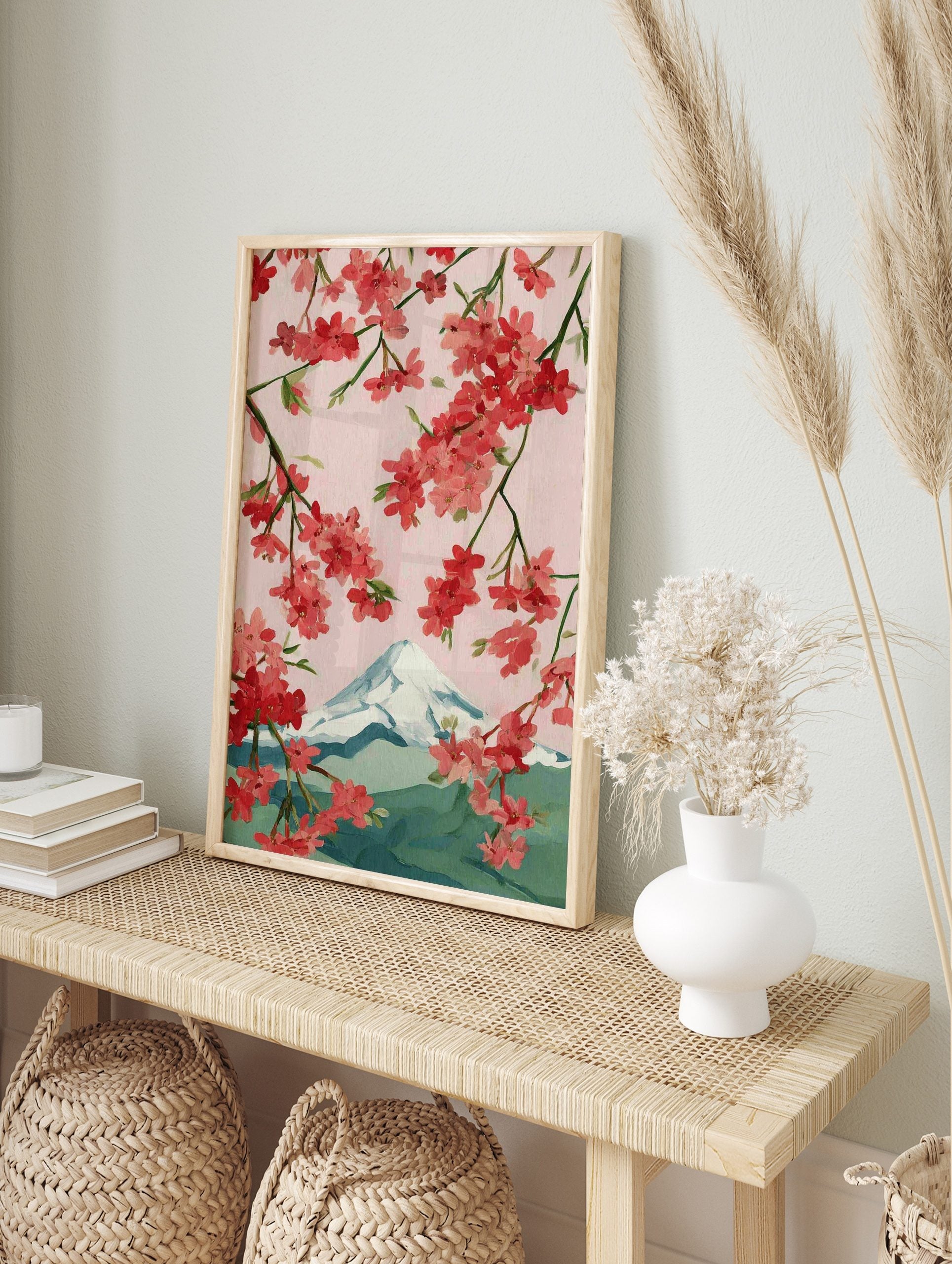 Illustrative cherry blossom branches with pink and red flowers framing snow-capped Mount Fuji, in an alternate framed mockup