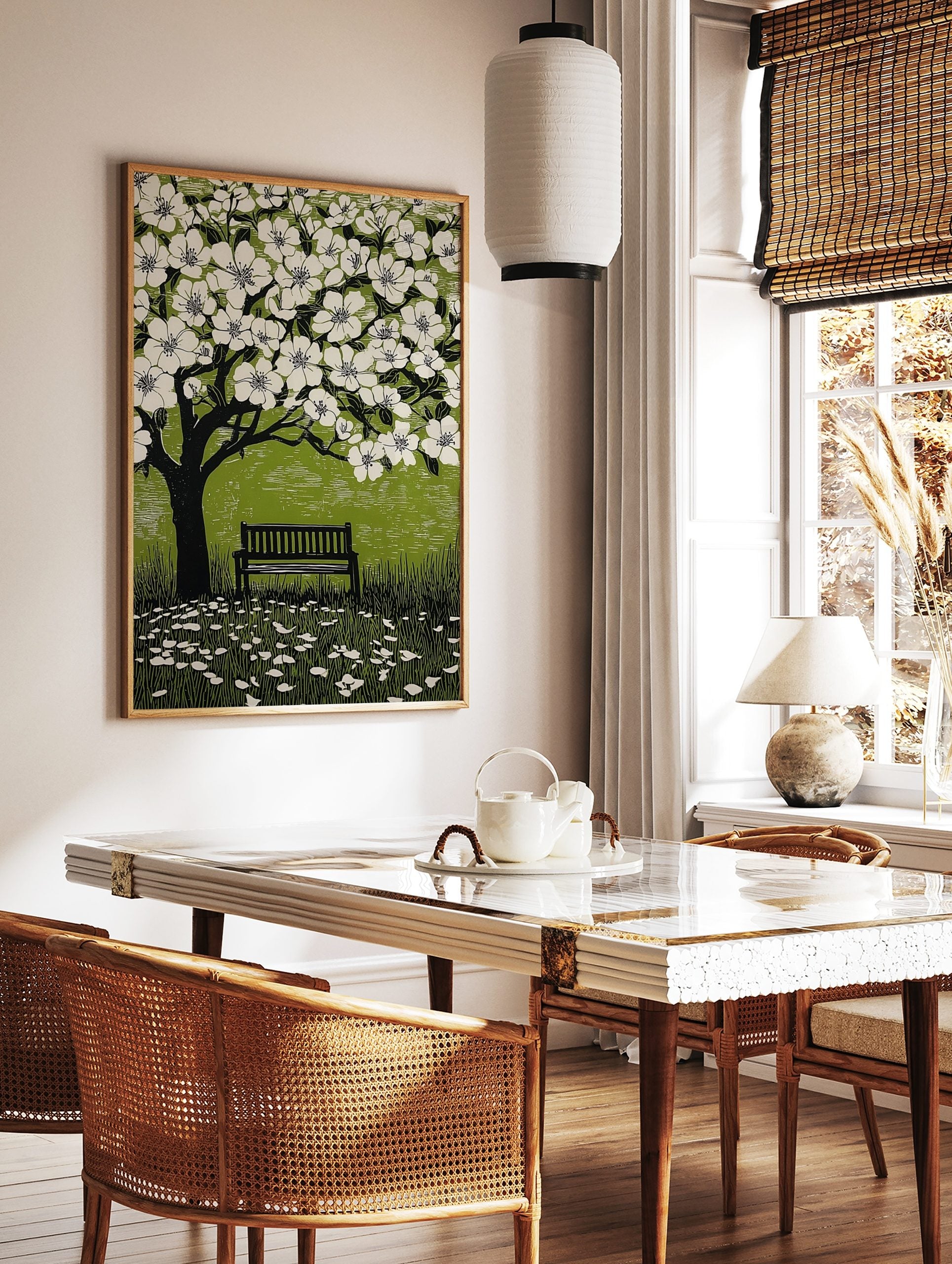Illustrative linocut print of a black tree with white cherry blossoms, green background, and a park, in a styled room mockup
