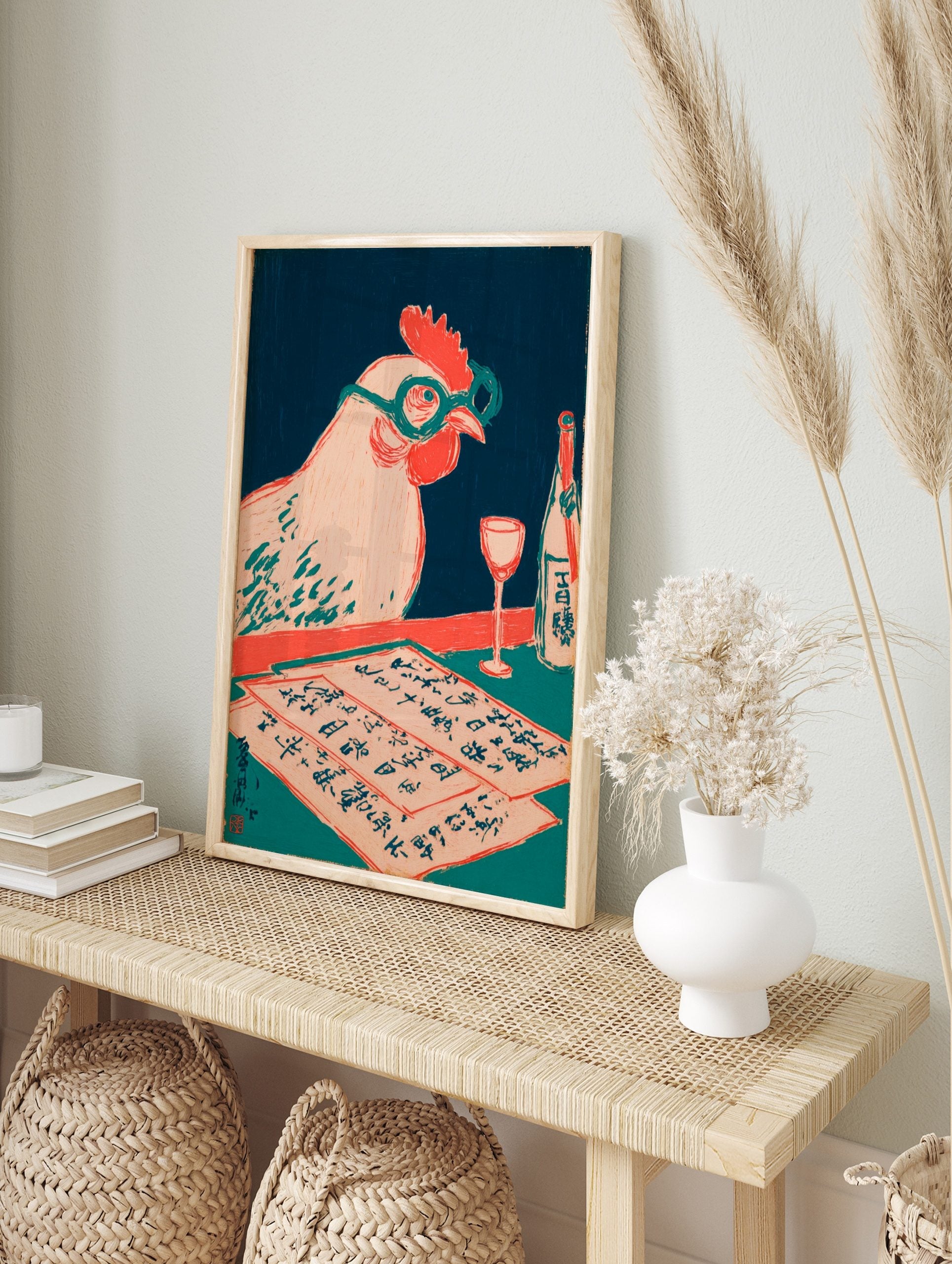 Illustrative woodcut print of a chicken with glasses, Japanese script papers, wine glass, and, in an alternate framed mockup