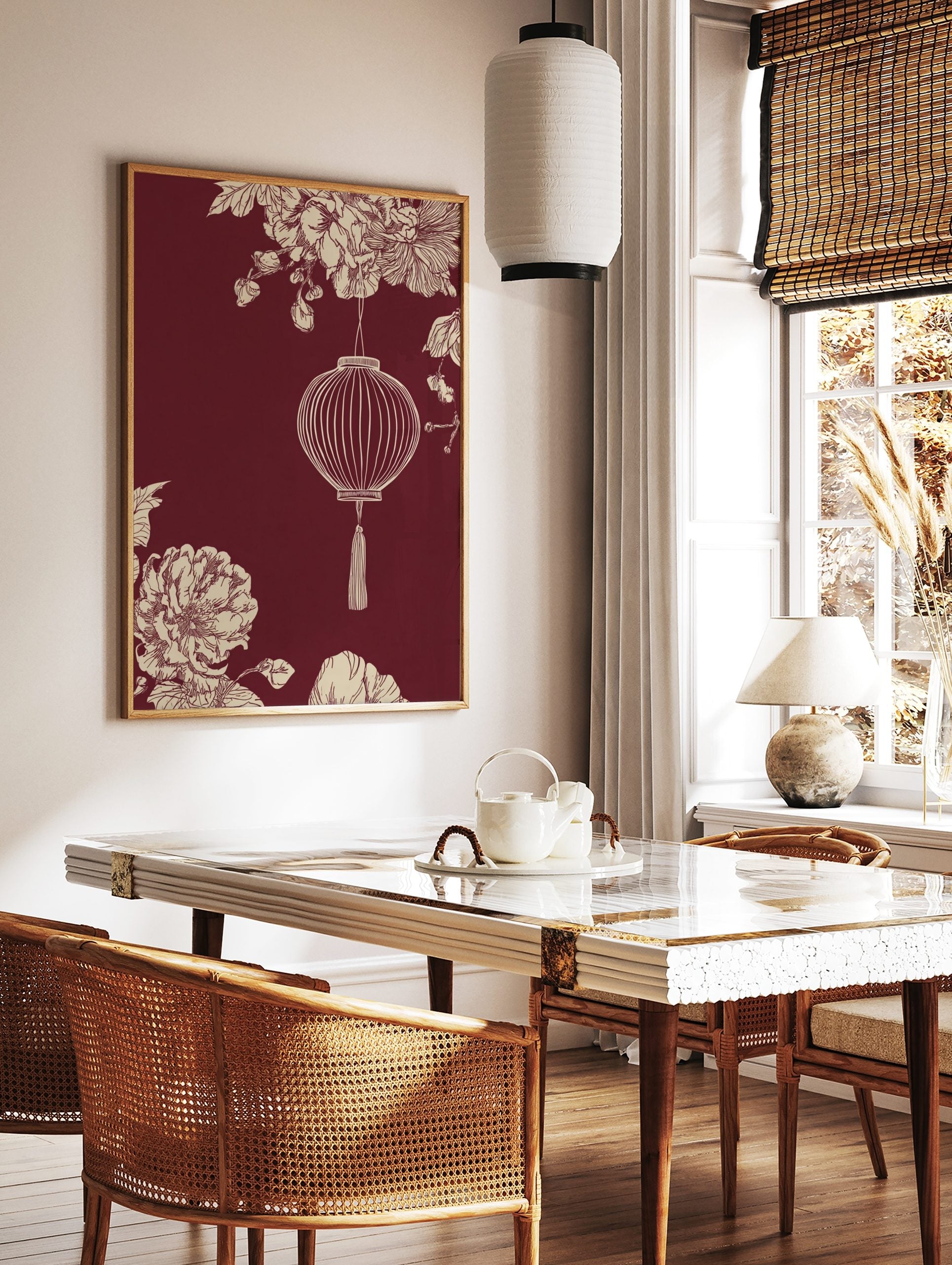 Illustrative Chinese lantern with tassel, cream botanical flowers, and foliage on a maroon, in a styled room mockup
