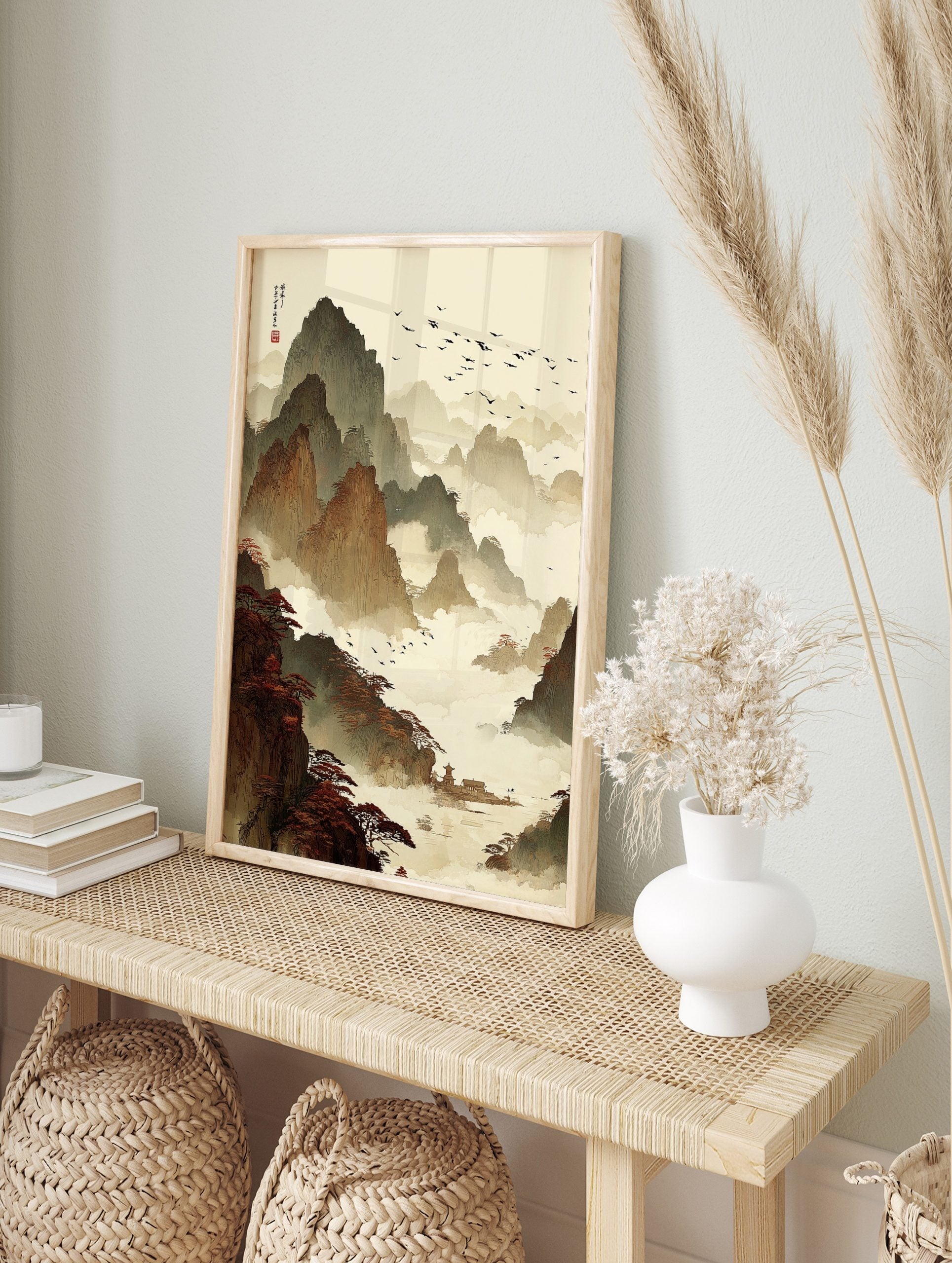 Traditional Chinese ink wash painting of layered mountains, misty clouds, flying birds, red, in an alternate framed mockup