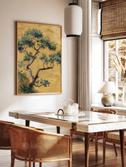 Chinoiserie tree illustration with green and blue leaves, gnarled trunk, on a golden-yellow, in a styled room mockup