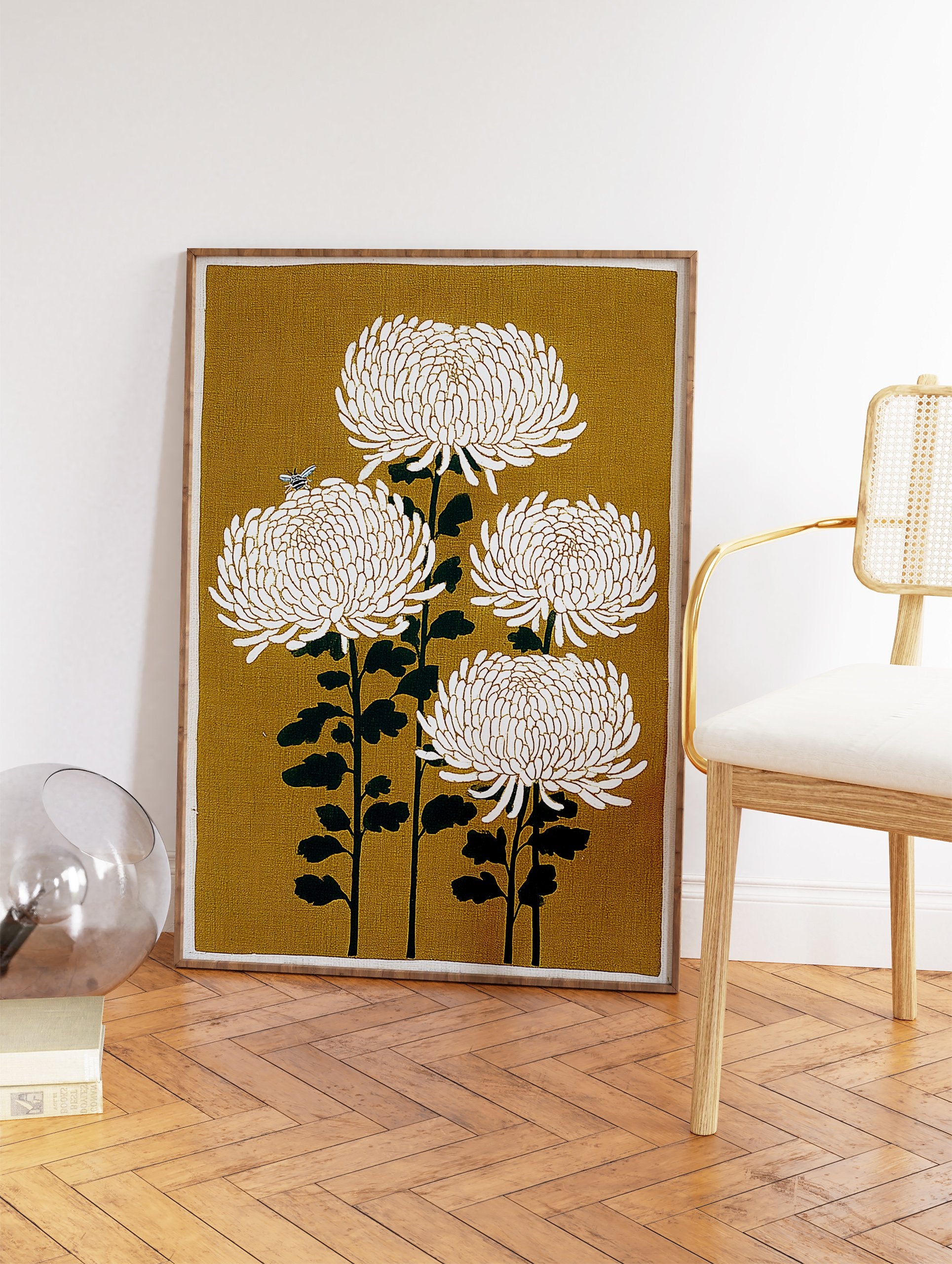 Four white chrysanthemum flowers on dark green stems with a bee on a mustard yellow background. Japanese botanical wall art print. - Image 2
