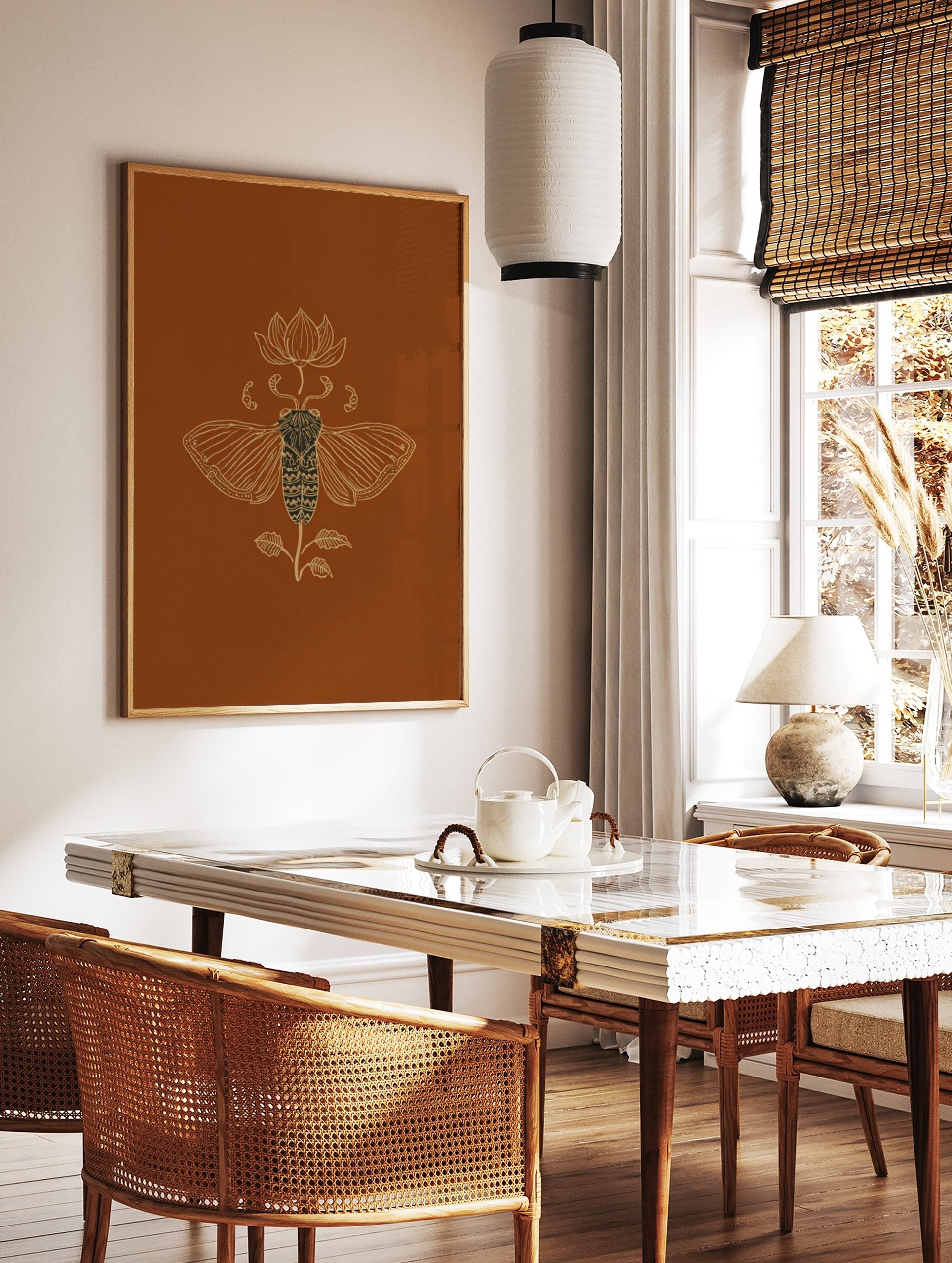 Ornate golden line art illustration of a cicada and lotus flower on a rich brown background, in a styled room mockup