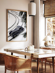 Navy blue classic car on snow-covered train tracks, high-angle view with pine branches and curving, in a styled room mockup