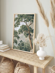 Classic illustrative tree landscape print with dense green foliage, brown trunks, and hazy, in an alternate framed mockup