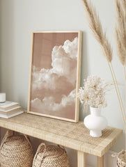 Sepia tone photo of fluffy cumulus clouds filling the sky, creating an abstract and peaceful, in an alternate framed mockup