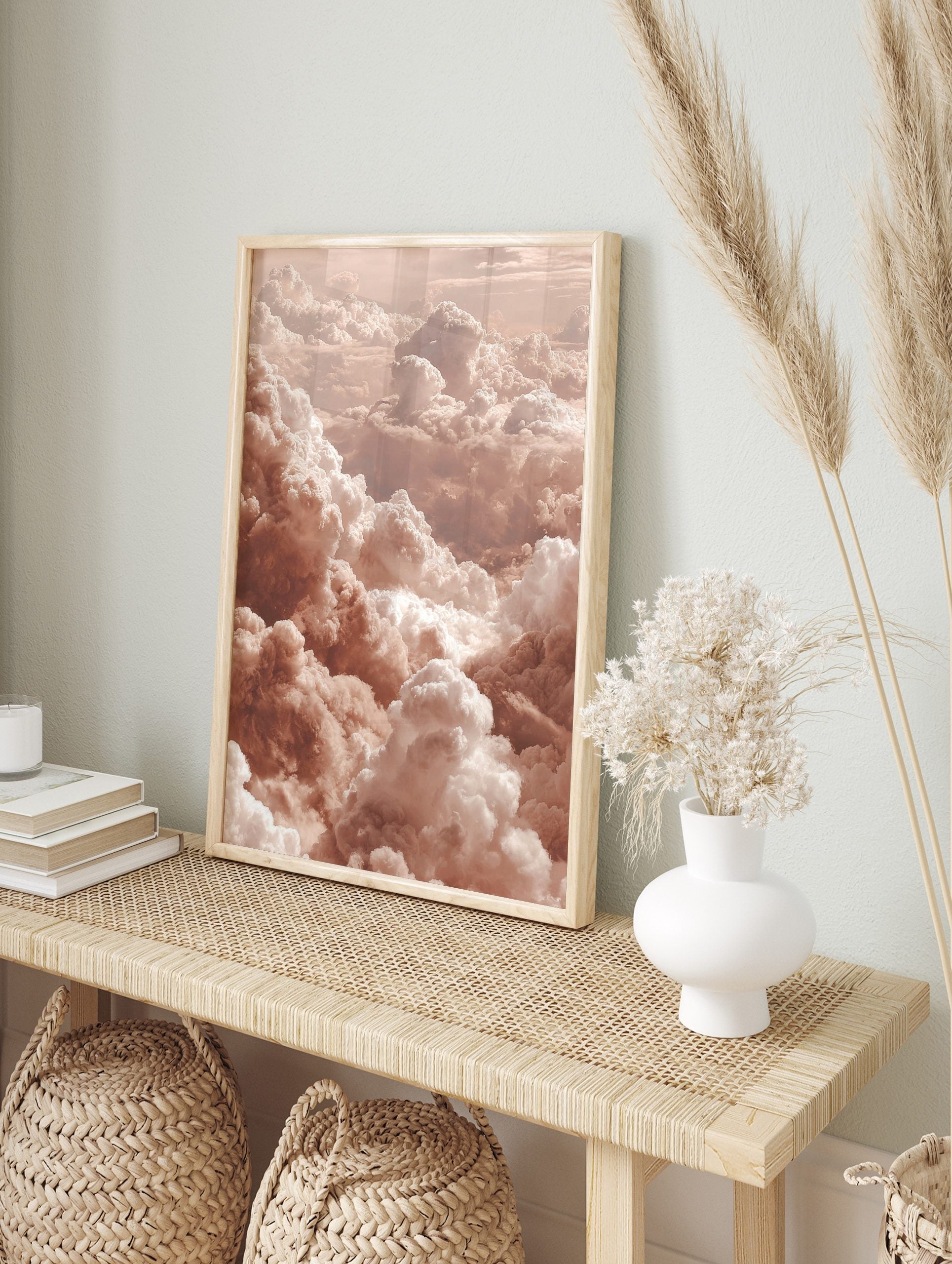 Aerial view of fluffy cumulus clouds in warm peach and white earth tones, filling the frame, in an alternate framed mockup