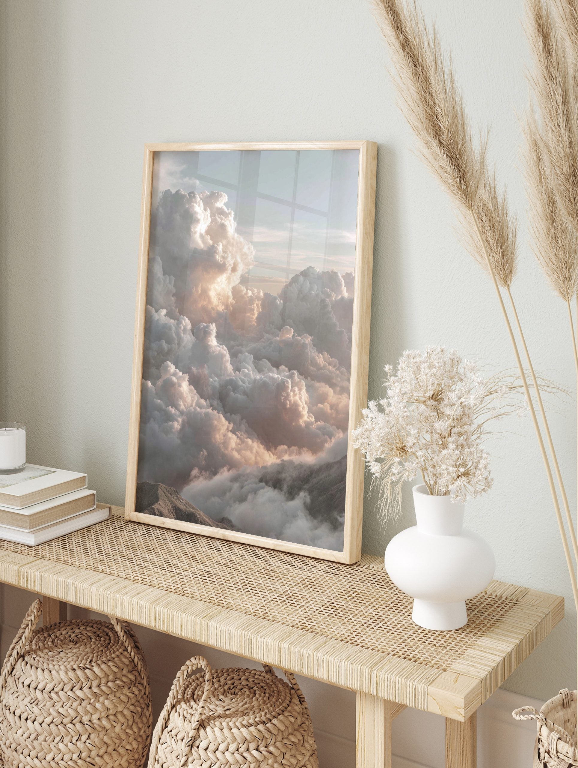 Majestic cumulus clouds with warm light over mountain peaks in a serene cloudscape wall art, in an alternate framed mockup