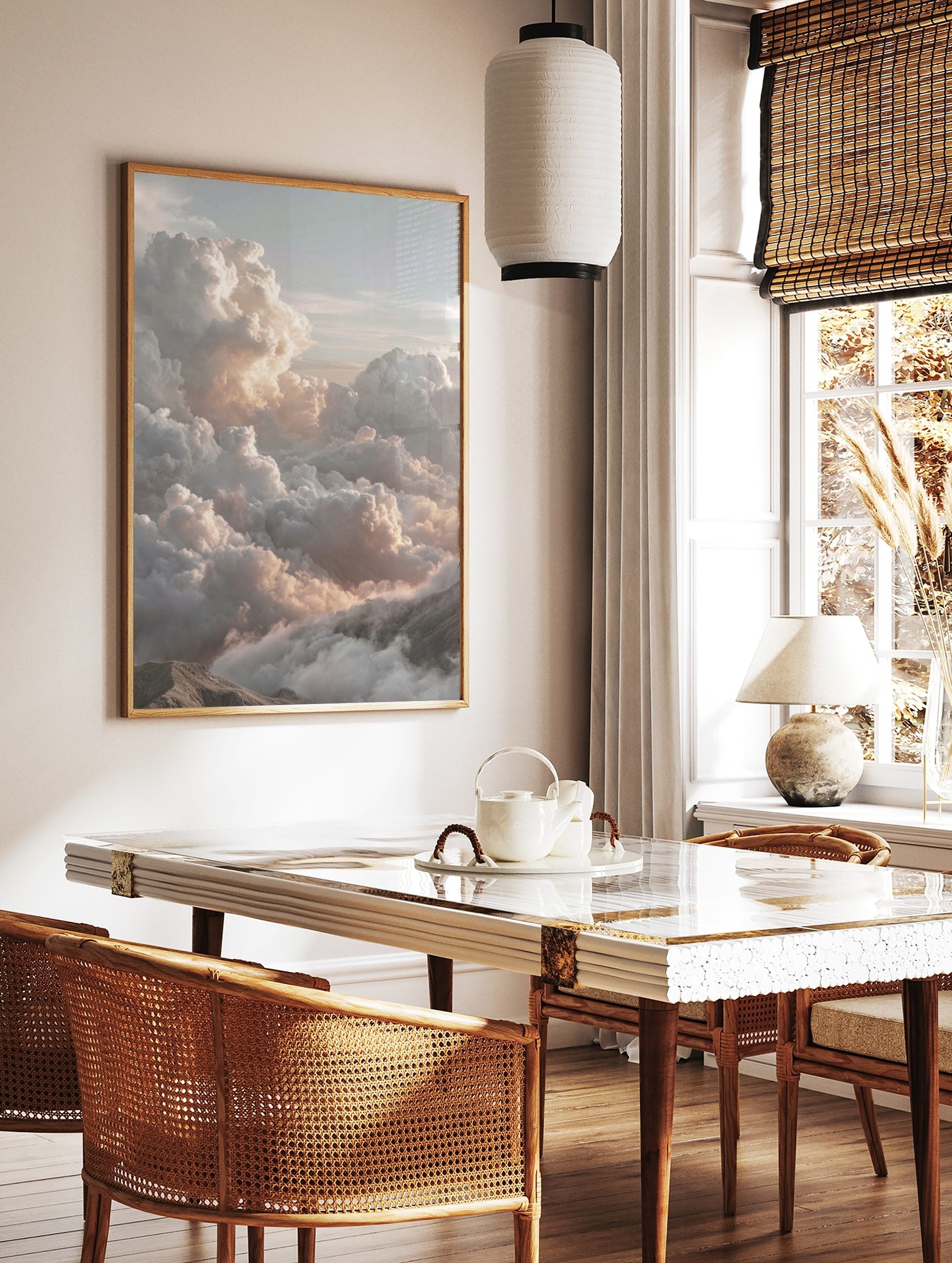 Majestic cumulus clouds with warm light over mountain peaks in a serene cloudscape wall art print, in a styled room mockup