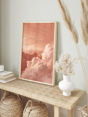 Voluminous white and pink clouds against a peach-toned sky, creating an abstract cloudscape, in an alternate framed mockup