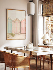 Photography poster of three weathered beach huts in pastel blue, pink, and striped cream on a sandy beach. - Image 2