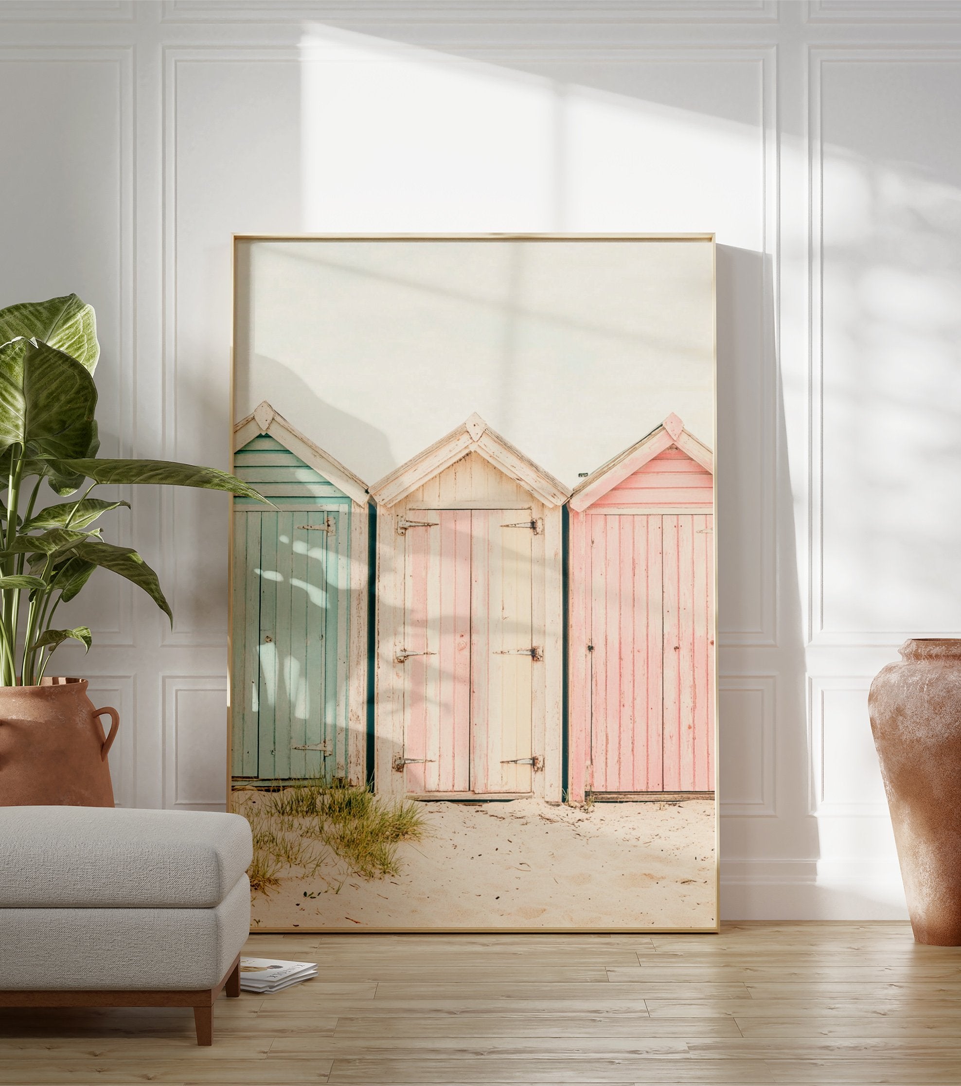 Photography poster of three weathered beach huts in pastel blue, pink, and striped cream on a sandy beach. - Image 3