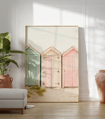 Photography poster of three weathered beach huts in pastel blue, pink, and striped cream on a sandy beach. - Image 3