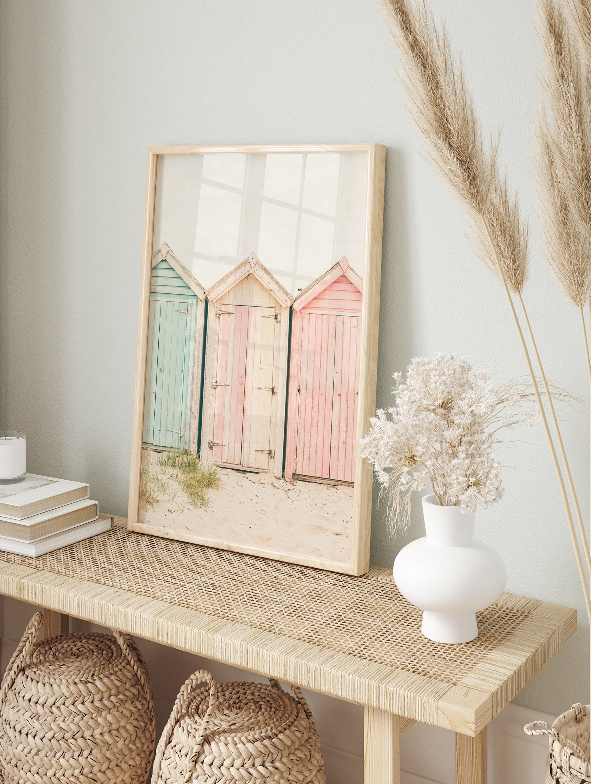 Photography poster of three weathered beach huts in pastel blue, pink, and striped cream on a sandy beach. - Image 4