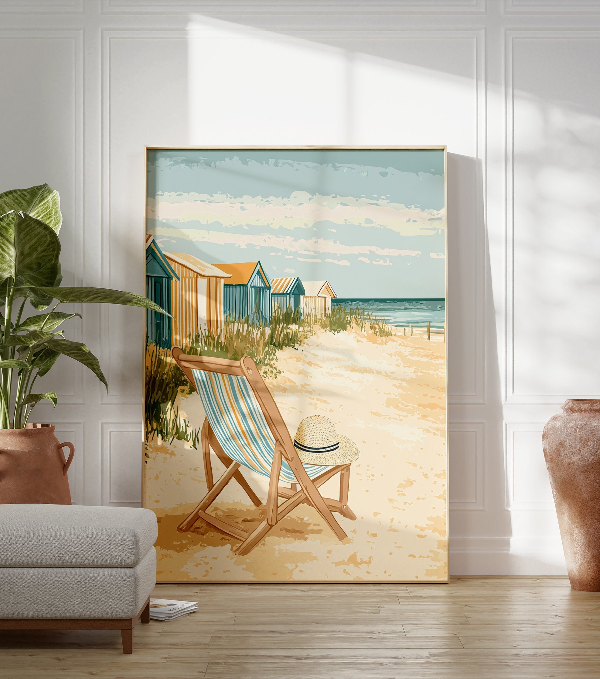 Coastal beach poster featuring a vintage illustration of beach huts, a striped deck chair with a straw hat, and the ocean. - Image 3