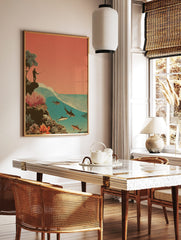 Illustrative print of a man fishing from a cliff, with a large wave and sharks in the salmon pink, in a styled room mockup