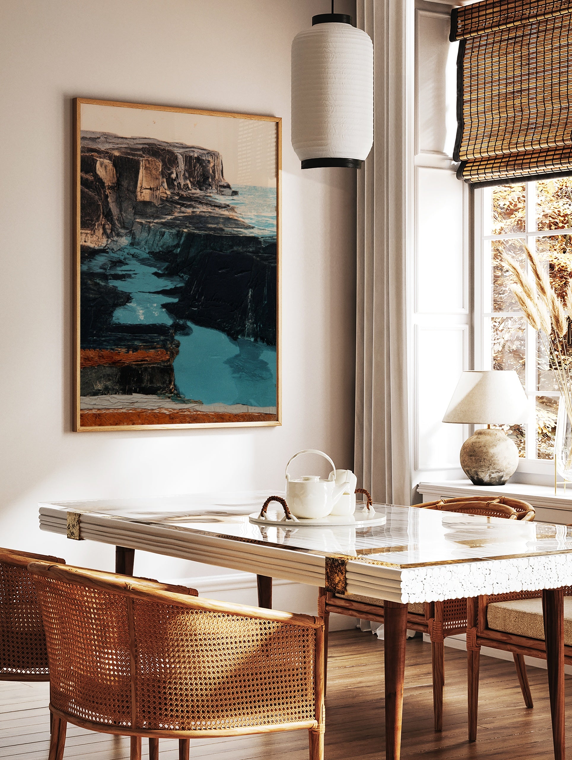 Coastal cliff wall art with dark rugged rock formations and vibrant turquoise water in an, in a styled room mockup