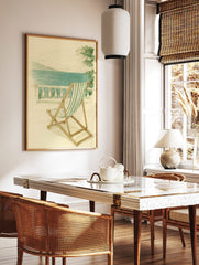 Illustrative print of green and white striped deckchair on balcony overlooking blue sea and distant, in a styled room mockup